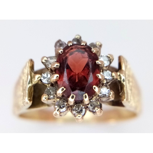 410 - A 9K Yellow Gold Garnet and Diamond Halo Patterned Band Ring, 0.12ct diamond weight, 0.55ct garnet w... 