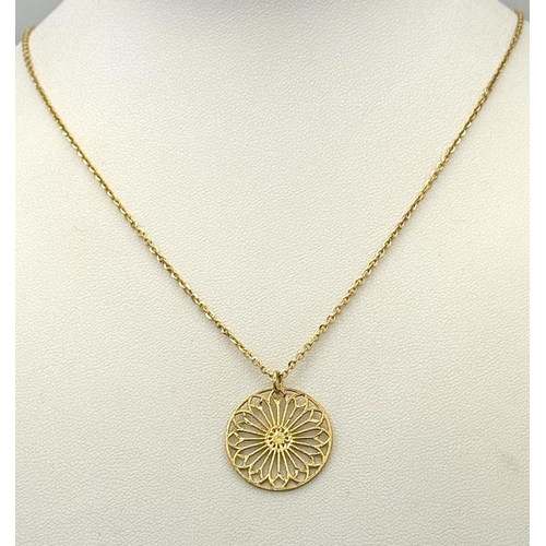 431 - A 9K yellow gold mandala design pendant on 18