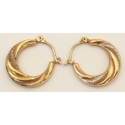 512 - A Pair of 9K Yellow and White Gold Creole Hoop Earrings. 1.5g total weight.