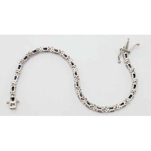 592 - Sterling Silver Sapphire Set Tennis Bracelet. 19cm Length. Set with Twenty-Two 5mm Oval Cut Sapphire... 