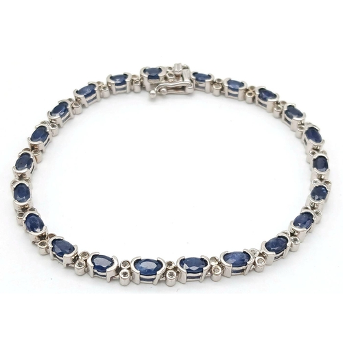 592 - Sterling Silver Sapphire Set Tennis Bracelet. 19cm Length. Set with Twenty-Two 5mm Oval Cut Sapphire... 