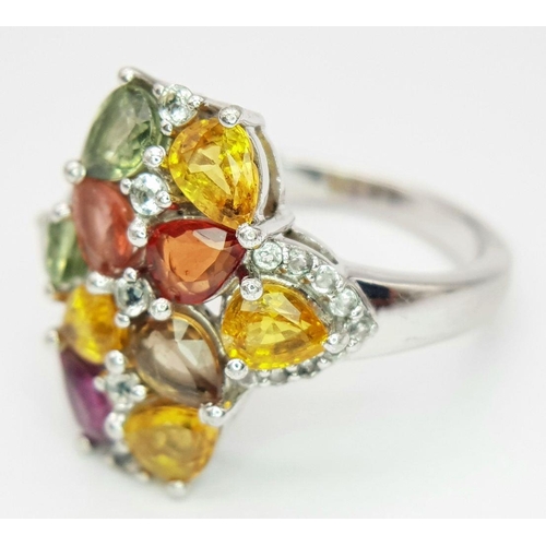 634 - A Sterling Silver Multi-Gemstone Set Ring Size Q. The Crown Measures 2cm Long and is set with Perido... 