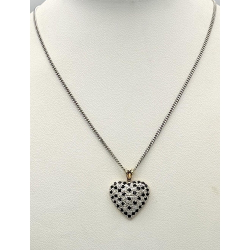 702 - A 9K Yellow Gold Sapphire Heart Pendant on a 9K White Gold Chain. Pendant 3cm. 44cm necklace length.... 