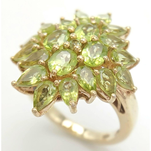 740 - A Yellow Gold Gilt Sterling Silver Peridot Set Statement Cluster Ring Size O1/2. The Crown Measures ... 