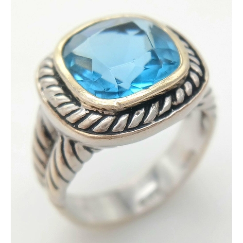 992 - A Vintage Celtic Design, Sterling Silver, Blue Topaz Set, Gold Highlight, Ring Size P. The Ring is s... 