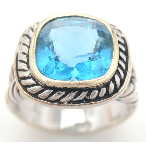 992 - A Vintage Celtic Design, Sterling Silver, Blue Topaz Set, Gold Highlight, Ring Size P. The Ring is s... 