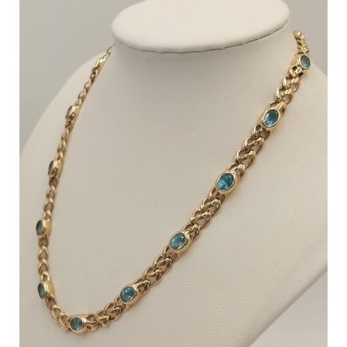 100 - A Gorgeous 9K Yellow Gold Aquamarine Necklace. Ice blue oval cuts of aquamarine between woven shaped... 