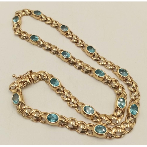 100 - A Gorgeous 9K Yellow Gold Aquamarine Necklace. Ice blue oval cuts of aquamarine between woven shaped... 