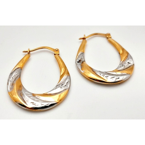 1010 - A Pair of 9K Yellow and White Gold Creole Earrings. 1g