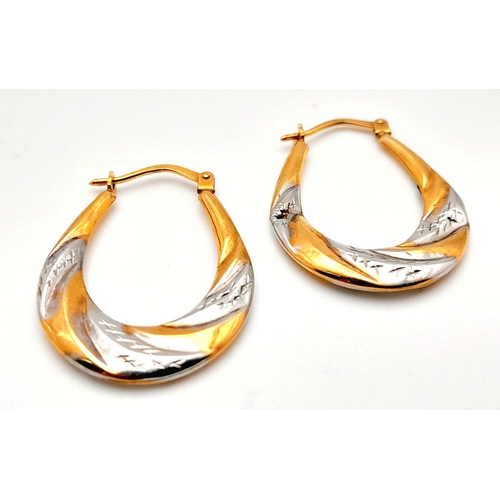 1010 - A Pair of 9K Yellow and White Gold Creole Earrings. 1g