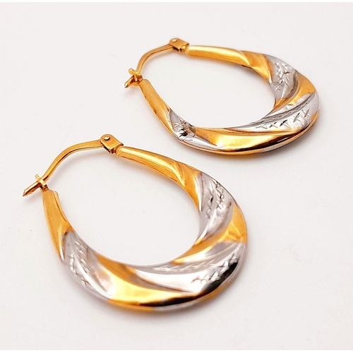 1010 - A Pair of 9K Yellow and White Gold Creole Earrings. 1g