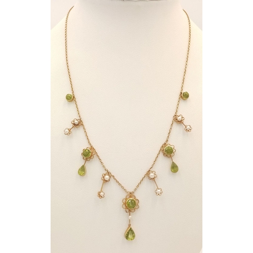 267 - An Antique 15K Peridot and Pearl Necklace. Hanging round and pear shaped peridots with seed pearl ba... 