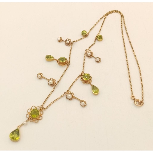 267 - An Antique 15K Peridot and Pearl Necklace. Hanging round and pear shaped peridots with seed pearl ba... 