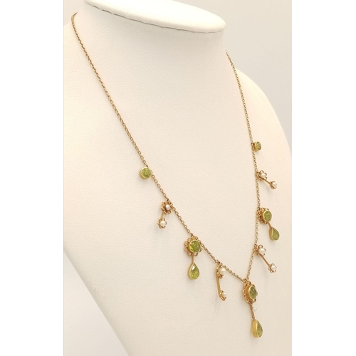 267 - An Antique 15K Peridot and Pearl Necklace. Hanging round and pear shaped peridots with seed pearl ba... 