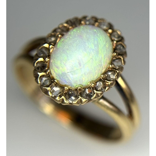 306 - A 14K Yellow Gold (tested as) Opal and Diamond Halo Ring, 0.16ct diamond weight, 10x7mm opal size, 3... 