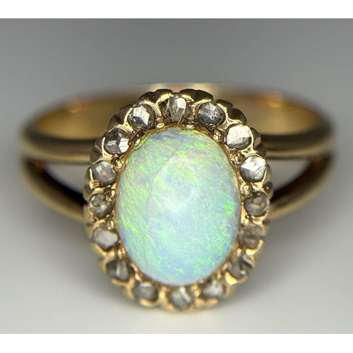 306 - A 14K Yellow Gold (tested as) Opal and Diamond Halo Ring, 0.16ct diamond weight, 10x7mm opal size, 3... 