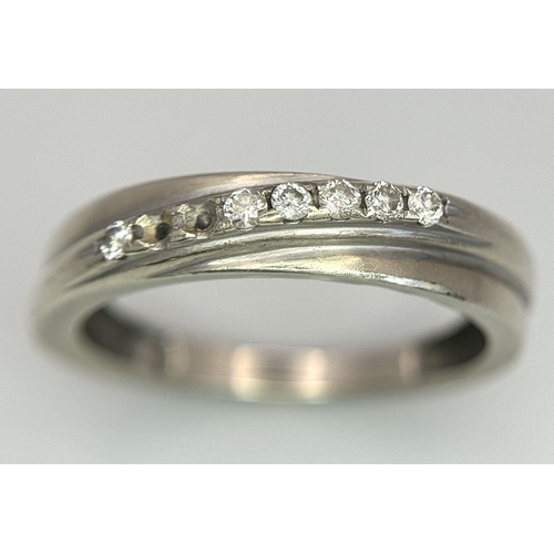 558 - A 9K WHITE GOLD DIAMOND CROSSOVER TWIST RING 2.47G SIZE P (TWO STONES MISSING). Ref: A/S 1158