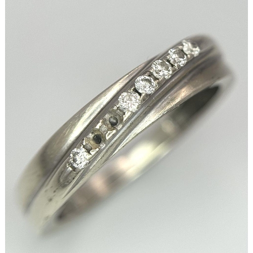 558 - A 9K WHITE GOLD DIAMOND CROSSOVER TWIST RING 2.47G SIZE P (TWO STONES MISSING). Ref: A/S 1158