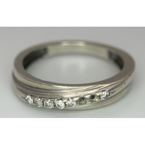 558 - A 9K WHITE GOLD DIAMOND CROSSOVER TWIST RING 2.47G SIZE P (TWO STONES MISSING). Ref: A/S 1158