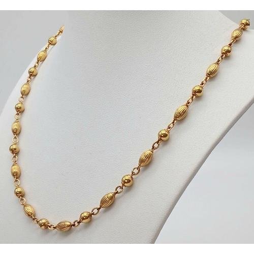 57 - A Delightful 9K Yellow Gold Coffee Bean-Esque and Bauble Link Chain. 50cm length. 17.1g weight.