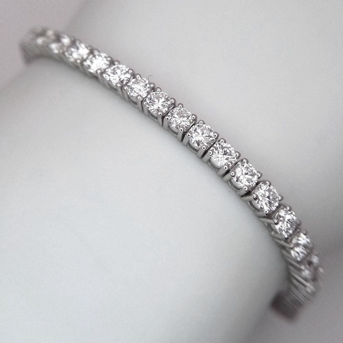 6 - A 18K WHITE GOLD DIAMOND SET TENNIS BRACELET 5.50CT 12.58G. Ref: A/S RED