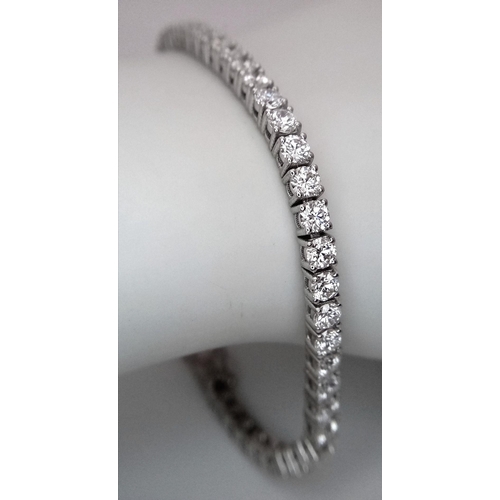 6 - A 18K WHITE GOLD DIAMOND SET TENNIS BRACELET 5.50CT 12.58G. Ref: A/S RED