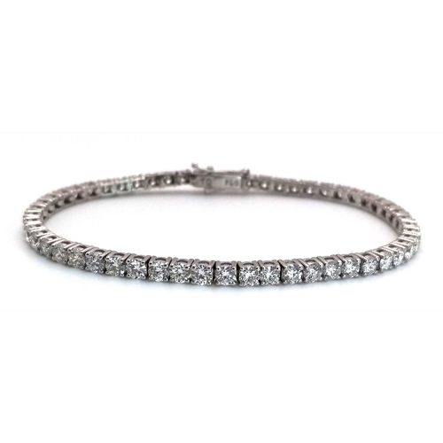 6 - A 18K WHITE GOLD DIAMOND SET TENNIS BRACELET 5.50CT 12.58G. Ref: A/S RED