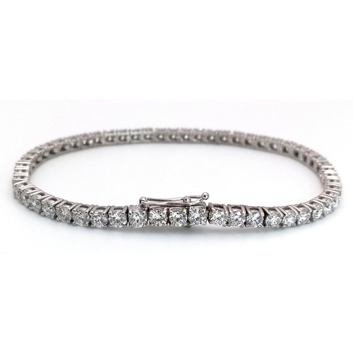 6 - A 18K WHITE GOLD DIAMOND SET TENNIS BRACELET 5.50CT 12.58G. Ref: A/S RED