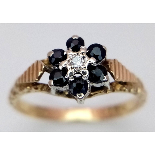 649 - A 9K YELLOW GOLD DIAMOND & SAPPHIRE SET, IN THE FLORAL DESIGN RING 2.1G SIZE N. Ref: SC 4004