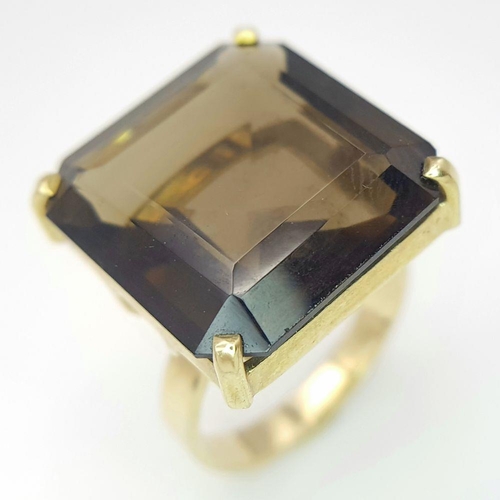 723 - A Classic 9K Yellow Gold Smoky Quartz Dress Ring. Size M. 7.3g total weight.