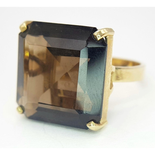 723 - A Classic 9K Yellow Gold Smoky Quartz Dress Ring. Size M. 7.3g total weight.