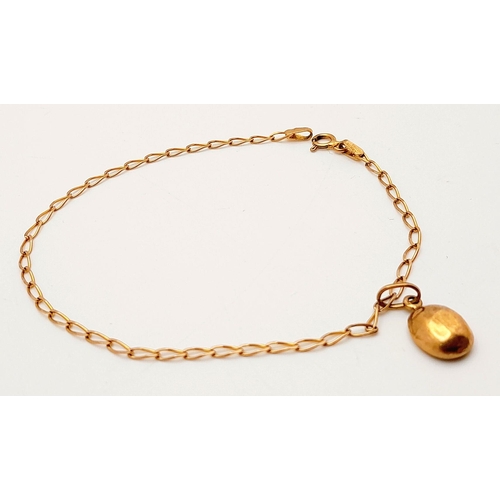 991 - A Delicate 9K Yellow Gold Bracelet with Hanging 9K Gold Coffee Pendant. 18cm length. 1.25g total len... 