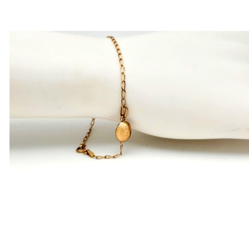 991 - A Delicate 9K Yellow Gold Bracelet with Hanging 9K Gold Coffee Pendant. 18cm length. 1.25g total len... 