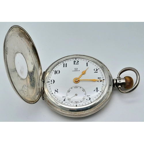 107 - An Antique Sterling Silver Omega Half-Hunter Pocket Watch. Top winder. 52mm diameter. White dial wit... 