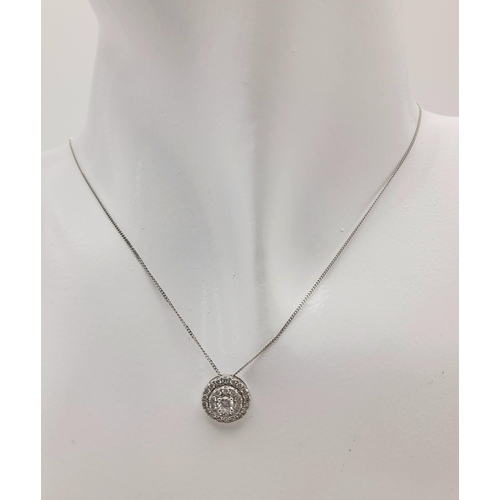 219 - A 9K White Gold and Diamond Circular Pendant on a 9K White Gold Disappearing Necklace. 0.5ctw double... 