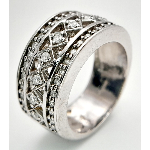 261 - A 9K WHITE GOLD DIAMOND SET FANCY DESIGN WIDE BAND RING 0.25CT 8.37G SIZE O. Ref: SC 4016