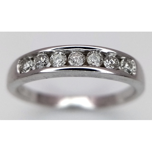 271 - A 18K WHITE GOLD DIAMOND 7 STONE RING. 0.20CT. TOTAL WEIGHT 2.6G. SIZE L. Ref: SC 4067