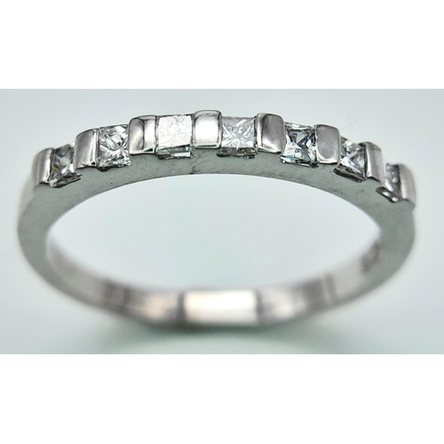 285 - A 18K WHITE GOLD DIAMOND 1/2 ET RING WITH PRINCESS CUTS. 0.25CT. TOTAL WEIGHT 2.6G. SIZE M AND 1/2. ... 