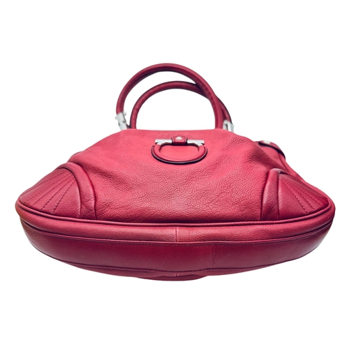 326 - A Salvatore Ferragamo Red Leather Handbag. Saddle form silver tone hardware. Purple textile interior... 