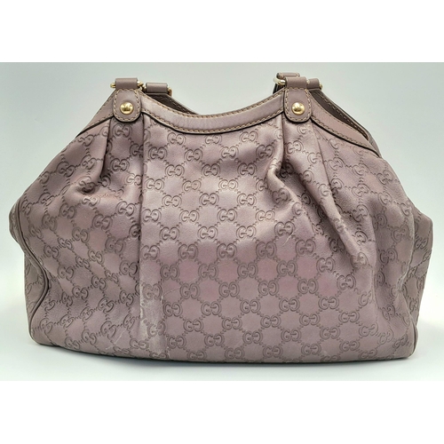 459 - A Gucci Sukey Tote Bag. Mauve leather exterior with GG monogram embossed, light gold-toned hardware,... 