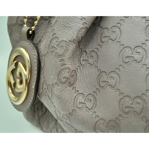 459 - A Gucci Sukey Tote Bag. Mauve leather exterior with GG monogram embossed, light gold-toned hardware,... 