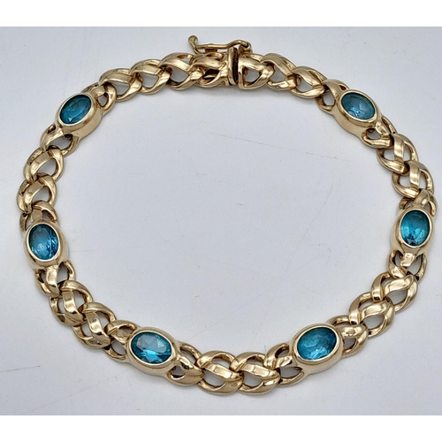 93 - A Gorgeous 9K Yellow Gold Aquamarine Bracelet. Ice blue oval cuts of aquamarine between woven shaped... 