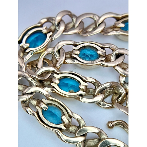 93 - A Gorgeous 9K Yellow Gold Aquamarine Bracelet. Ice blue oval cuts of aquamarine between woven shaped... 