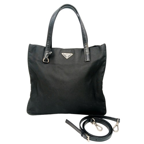 298 - A Prada Black Textile Hand/Shoulder bag. Black leather trim and handles. Removable shoulder strap. T... 