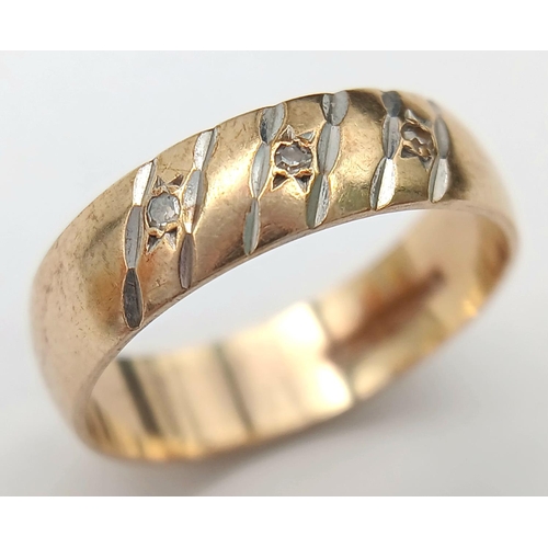 1012 - A 9K Yellow Gold Diamond Band Ring. Full UK hallmarks. Three small round cut diamonds. Size O 1/2. 3... 