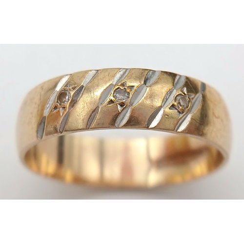 1012 - A 9K Yellow Gold Diamond Band Ring. Full UK hallmarks. Three small round cut diamonds. Size O 1/2. 3... 