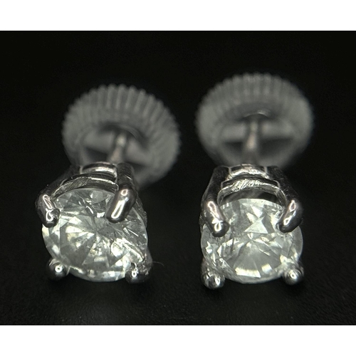 233 - A Pair of 18K White Gold Diamond Stud Earrings. 1ctw of brilliant round cut diamonds. 0.9g total wei... 