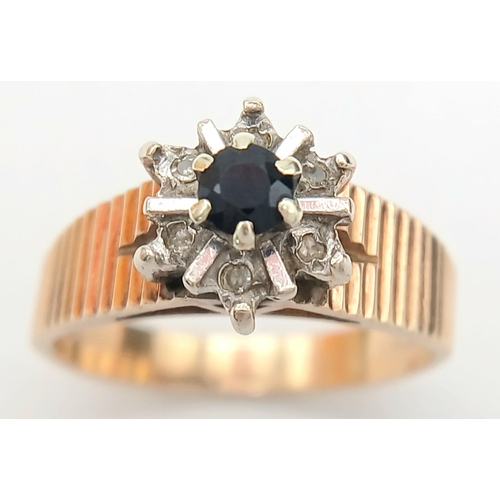 733 - A 9K Yellow Gold Sapphire and Diamond Ring. Central sapphire wit a rose cut diamond surround. Size N... 