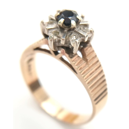 733 - A 9K Yellow Gold Sapphire and Diamond Ring. Central sapphire wit a rose cut diamond surround. Size N... 