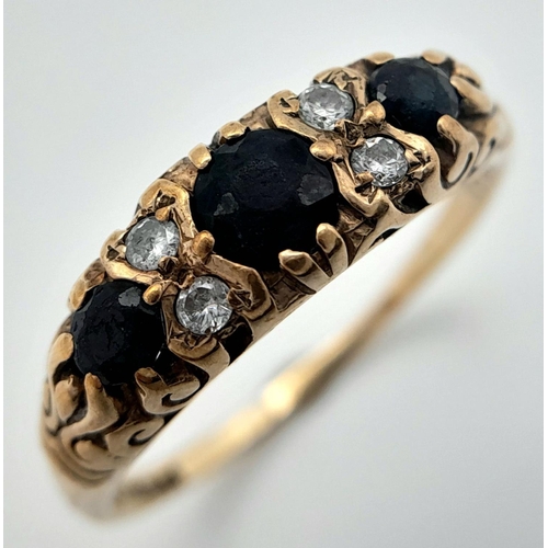 990 - A 9K Yellow Gold Diamond and Sapphire Ring. Three sapphires with diamond accents. Size P. 2.46g tota... 